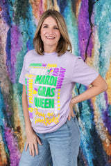 Woman wearing a 'Mardi Gras Queen' shirt against a colorful, abstract background