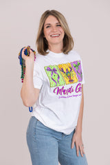 Woman wearing a white t-shirt with colorful graphics and text, holding a colorful bag against a beige background
