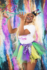 Person in colorful costume with butterfly wings against a vibrant, abstract background